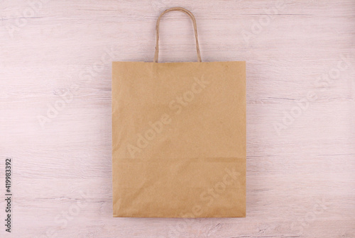 Paper bag on wooden background