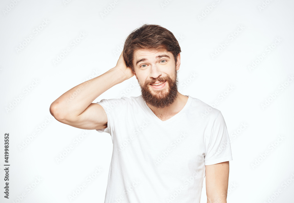 a man with a beard gestures with his hands on a light background Copy Space man a man with a beard gestures with his hands on a light background Copy Space man