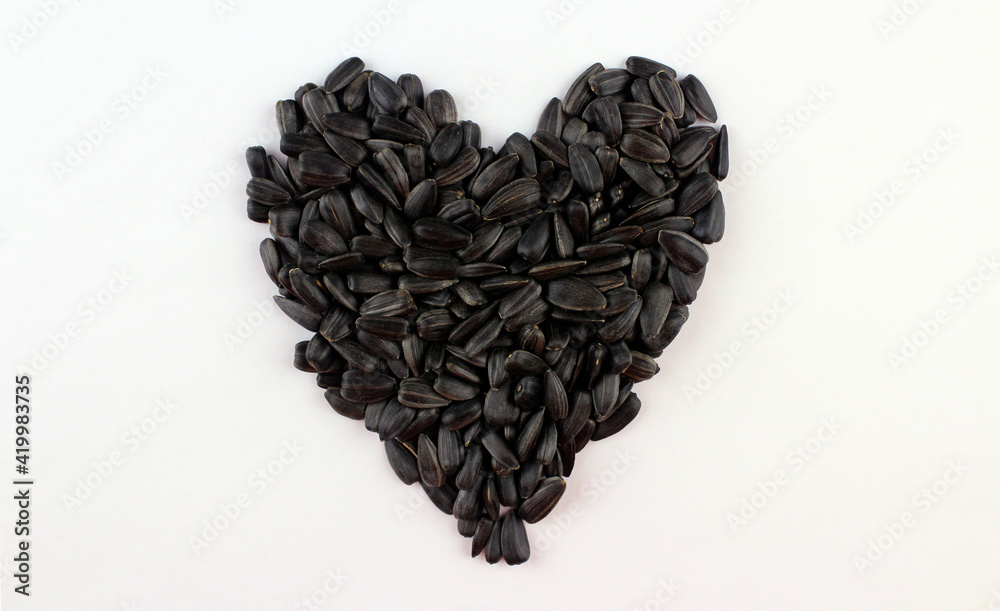 Heart of black sunflower seeds on white background Heart of black sunflower seeds on white background