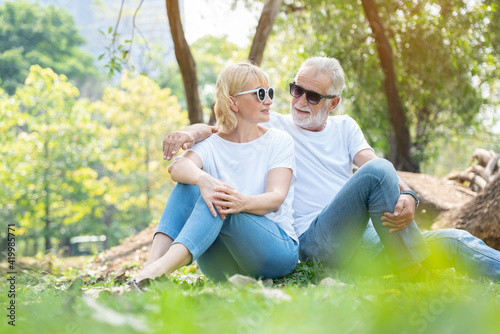 Senior Caucasian couples hugging in park. Family with happy smile feels relaxed with nature in morning. Or evening. Enter elderly society And retire from work. Concept Health care insurance © Rapeepat