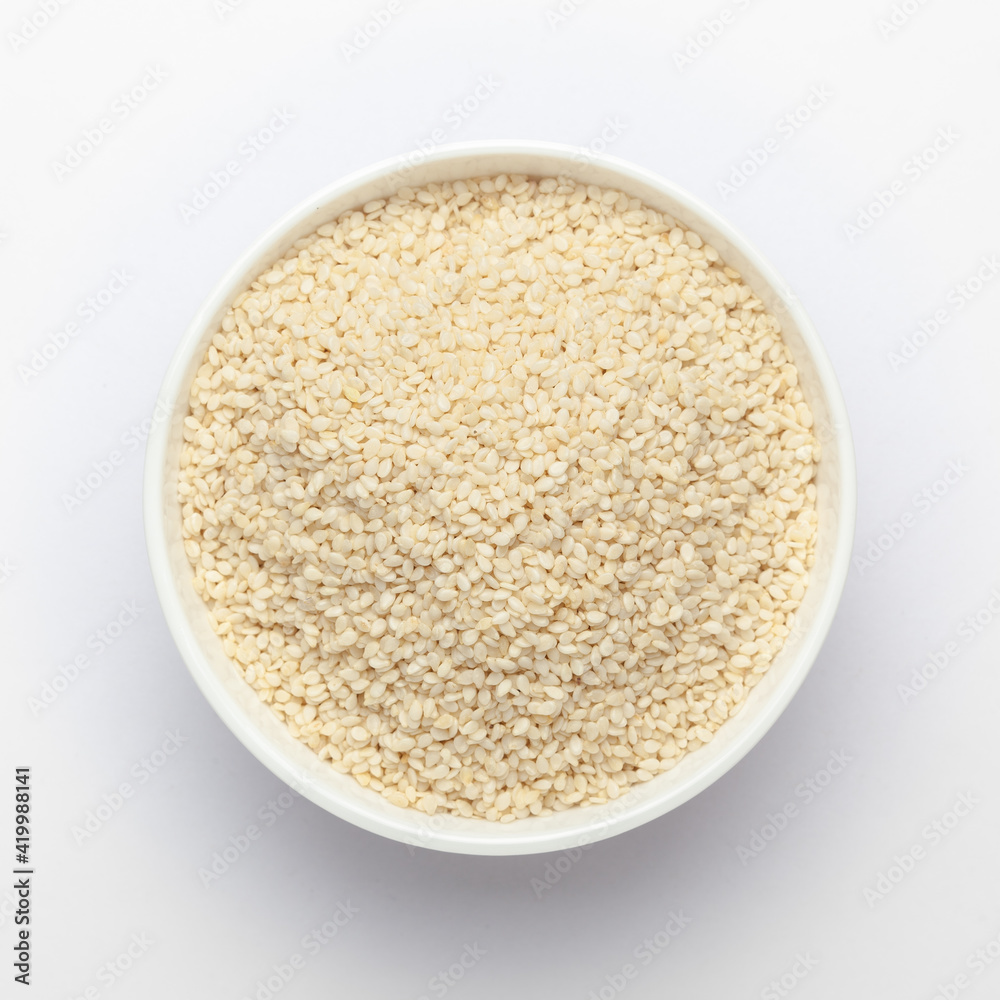 Organic White Sesame seeds(Sesamum indicum) polished or white Til without shell in white ceramic bowl Organic White Sesame seeds(Sesamum indicum) polished or white Til without shell in white ceramic bowl