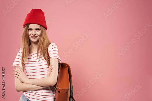 beautiful woman in fashion clothes red hat cropped view pink background