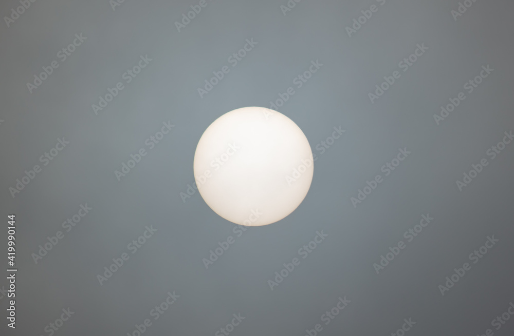 The sun shines behind the clouds during The sun shines behind the clouds during