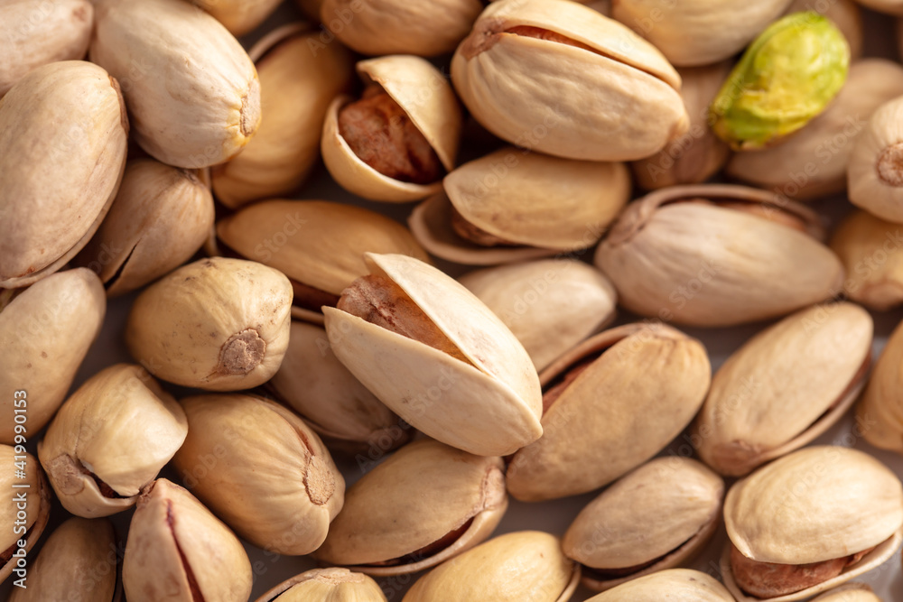 Close-up of fresh pistachio nuts as background.