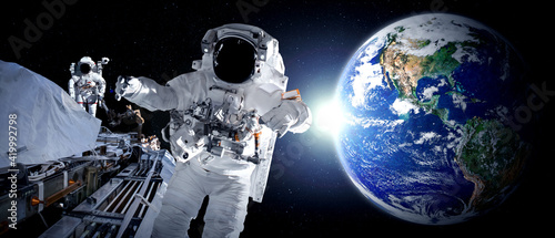 Fototapeta Naklejka Na Ścianę i Meble -  Astronaut spaceman do spacewalk while working for space station in outer space . Astronaut wear full spacesuit for space operation . Elements of this image furnished by NASA space astronaut photos.