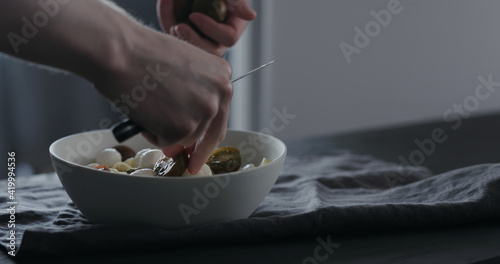 put kumato tomatoes on fettuccine in white bowl on linen cloth