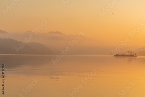 Sunrise over a misty riverside