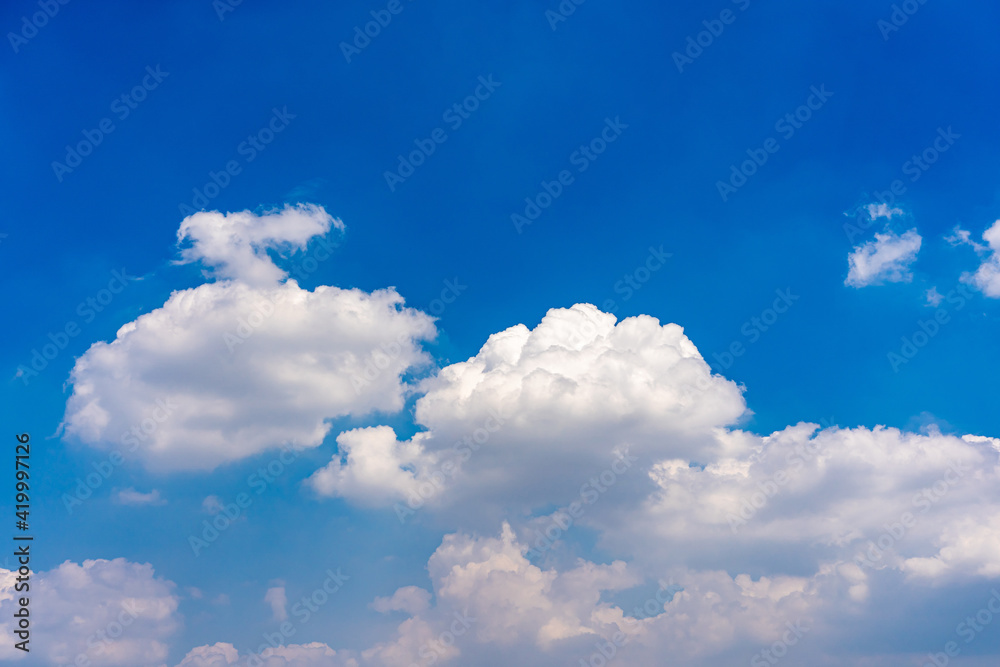 Cotton like white clouds on blue sky background 