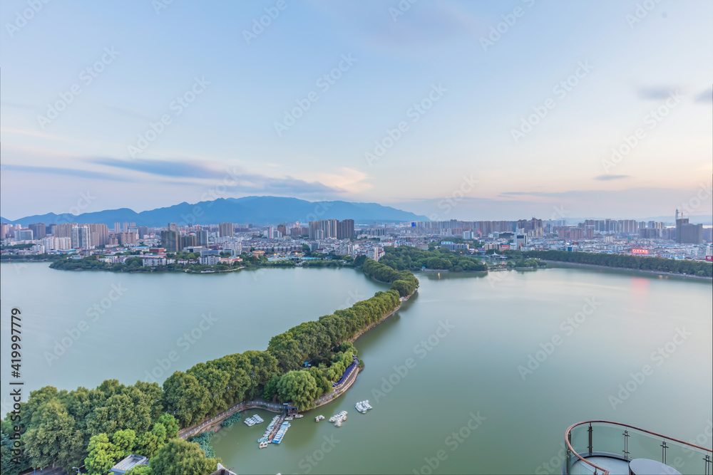 Overlooking the skyline of a city in southern China surrounded by mountains and rivers. Jiujiang, a medium-sized city in the Yangtze River Economic Belt, is located in the upstream of Shanghai, China.