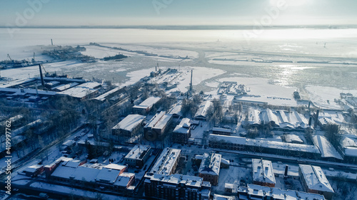 Panoramic aerial view of Kronstadt. Petrovskaya pier where the ships are. Coastline. Kotlin Island. Winter.