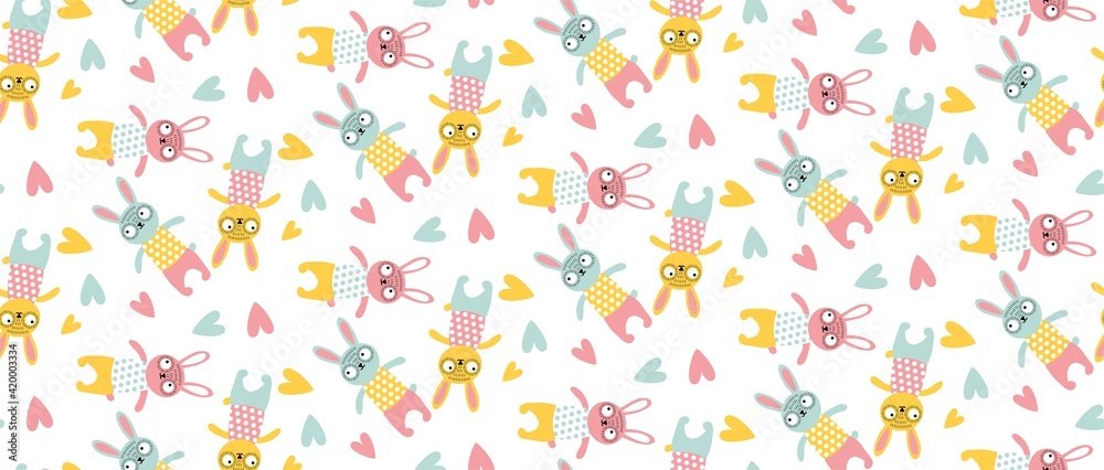 Vector seamless pattern with sewn bunnie, rabbit, heart in children's pastel colors. For printing on fabric, paper, nursery wallpaper, as background. Easter, baby fabric. Pink, yellow, blue. Isolated Vector seamless pattern with sewn bunnie, rabbit, heart in children's pastel colors. For printing on fabric, paper, nursery wallpaper, as background. Easter, baby fabric. Pink, yellow, blue. Isolated