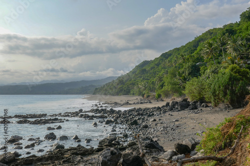 Landscape view of rocky tropical coastline on the Sawu sea near Sikka village, East Flores island, East Nusa Tenggara, Indonesia photo