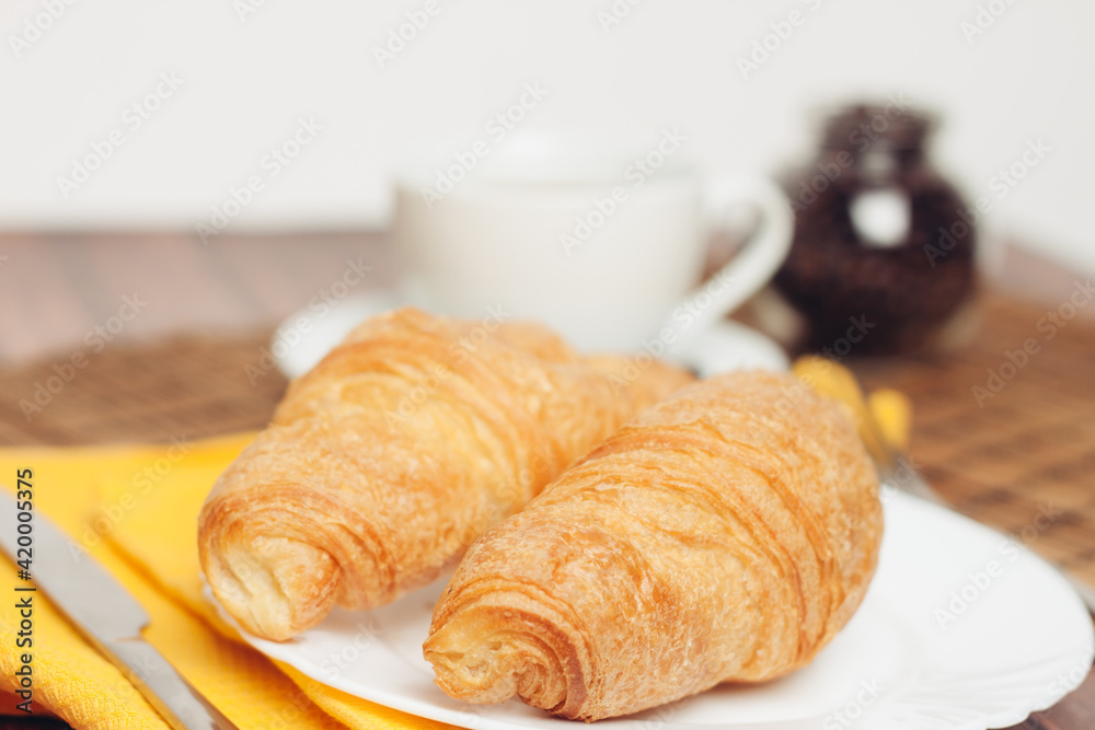 fresh croissants on a saucer table setting breakfast fresh croissants on a saucer table setting breakfast