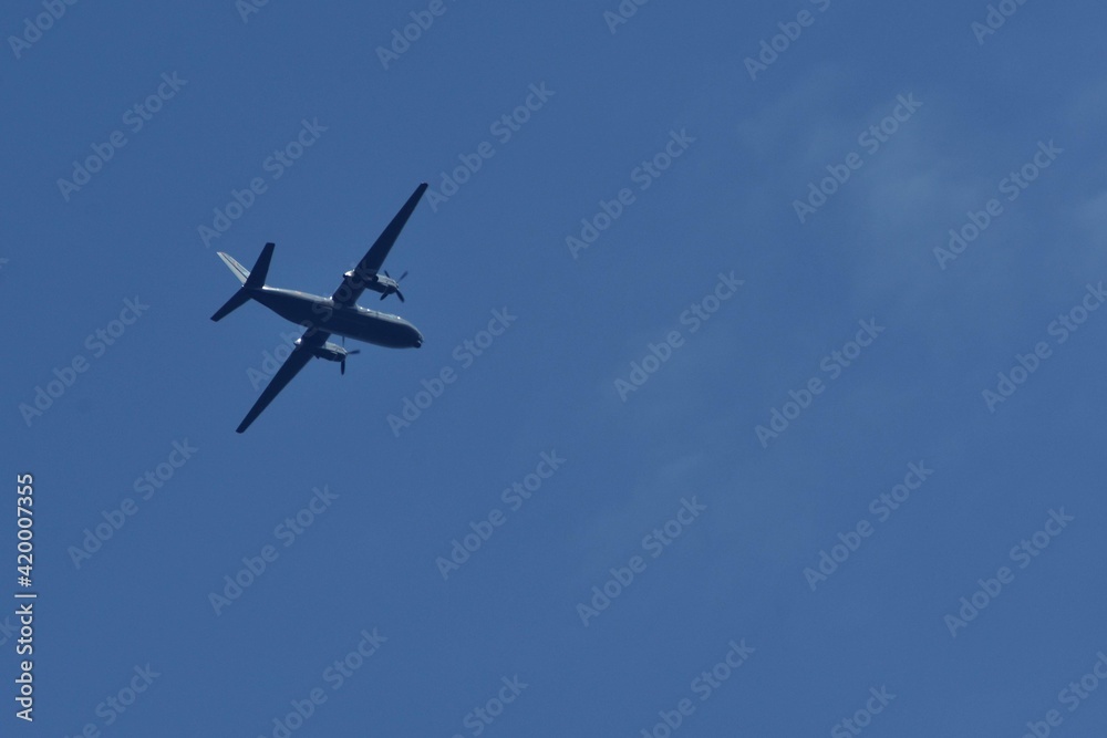 small plane with propellers flying in the blue sky. means of air transport small plane with propellers flying in the blue sky. means of air transport