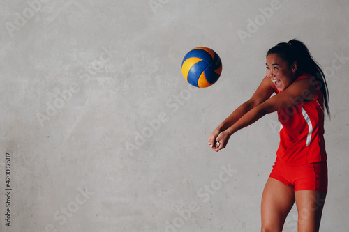 Young woman smiling volleyball player with ball photo