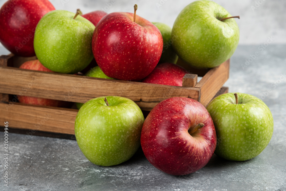 Fresh delicious green and red apples in wooden box Fresh delicious green and red apples in wooden box