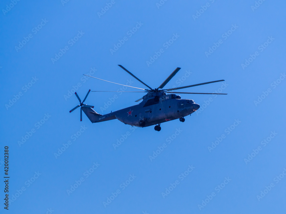 Russia, St. Petersburg - June 24, 2020: Russian transport helicopter Mil Mi-26 RF-06805 of the Russian Air Force in flight at Parade of Victory in World War II. Russia, St. Petersburg - June 24, 2020: Russian transport helicopter Mil Mi-26 RF-06805 of the Russian Air Force in flight at Parade of Victory in World War II.