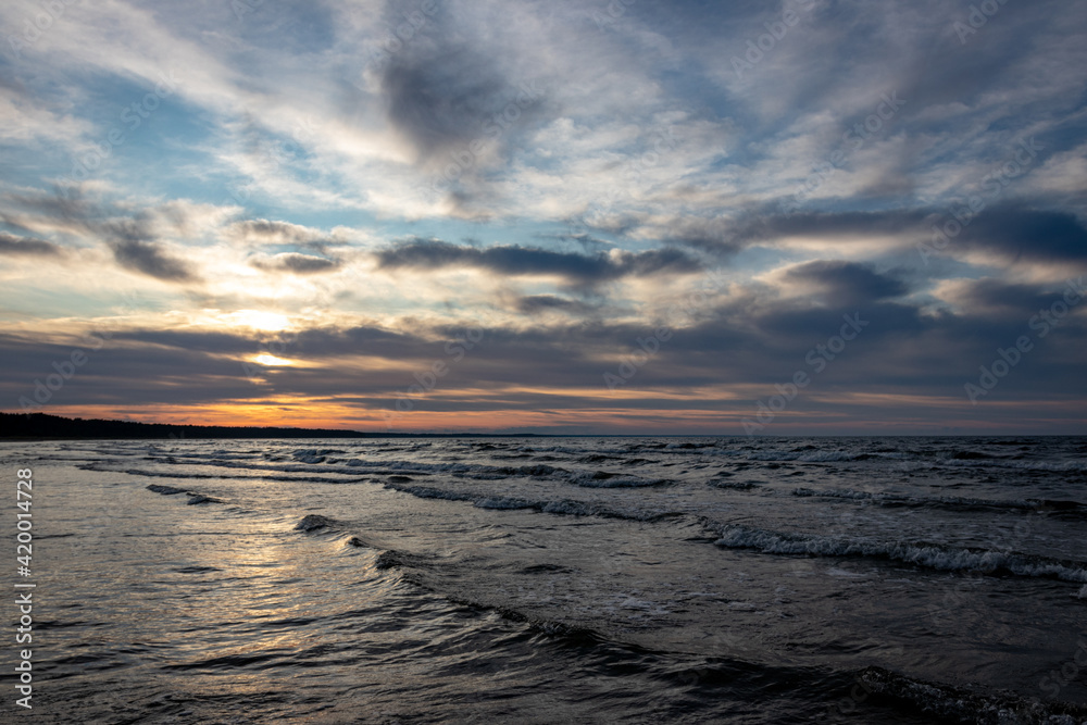 beautiful miraculous seascape without people, Baltic sea Riga gulf, waves in evening sunset