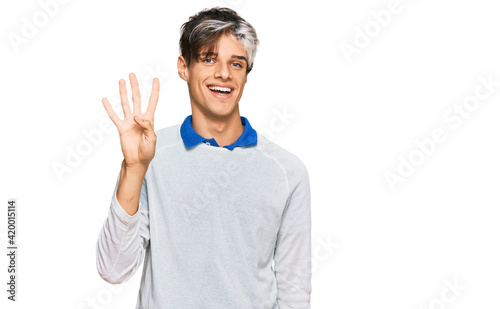 Young hispanic man wearing casual clothes showing and pointing up with fingers number four while smiling confident and happy. © Krakenimages.com