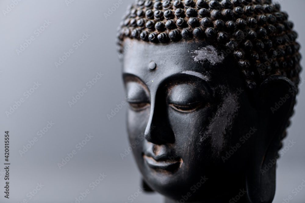 Meditating Buddha on gray background. Soft focus. Close up. Copy space. Meditating Buddha on gray background. Soft focus. Close up. Copy space.