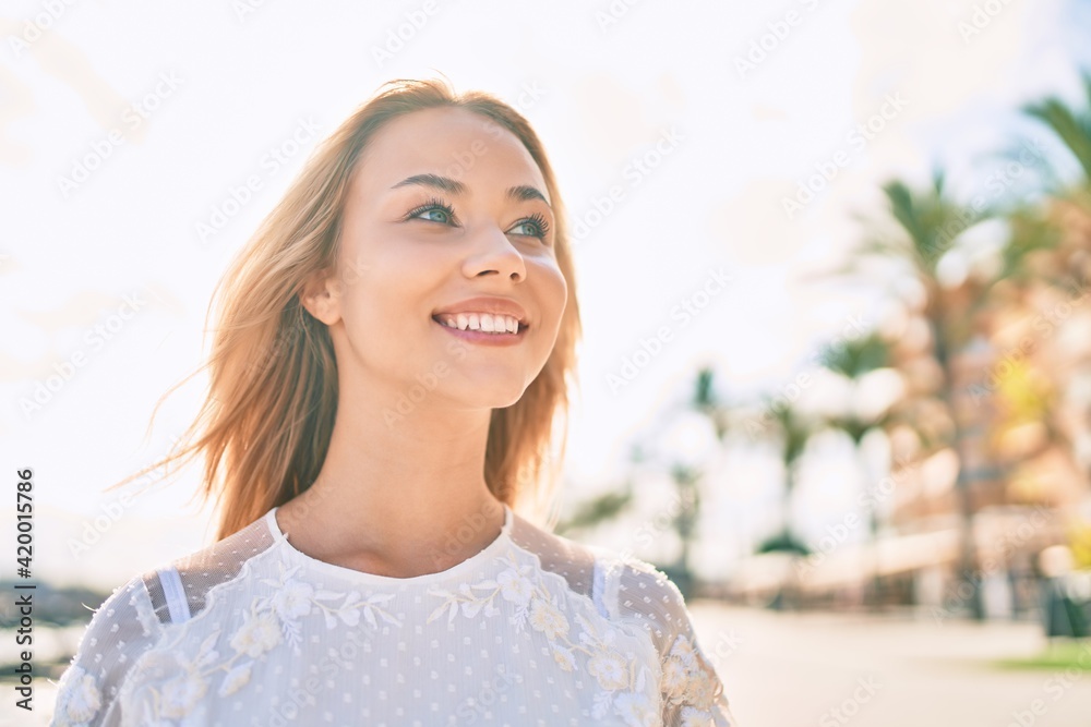 Young caucasian girl smiling happy walking at the promenade. Young caucasian girl smiling happy walking at the promenade.