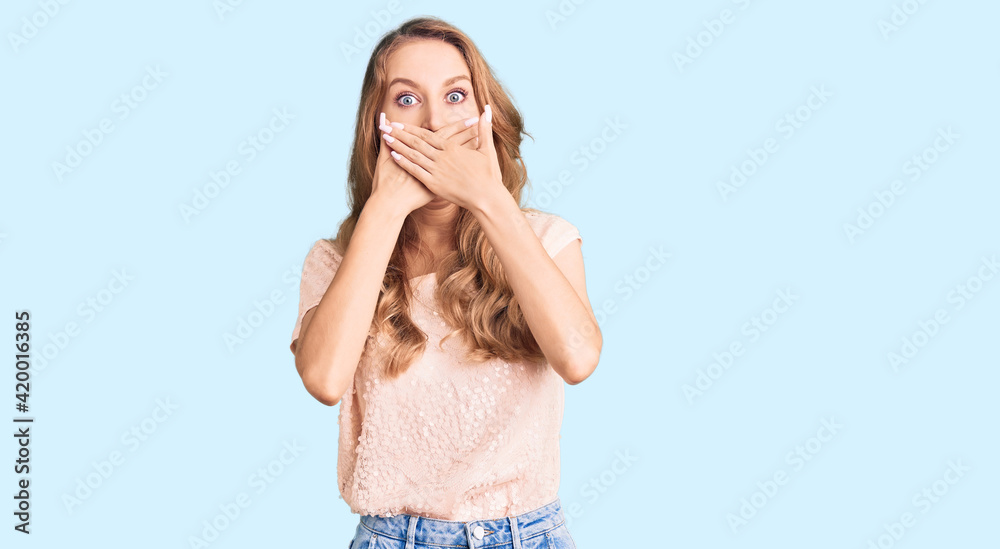 Young beautiful caucasian woman with blond hair wearing casual clothes shocked covering mouth with hands for mistake. secret concept. Young beautiful caucasian woman with blond hair wearing casual clothes shocked covering mouth with hands for mistake. secret concept.
