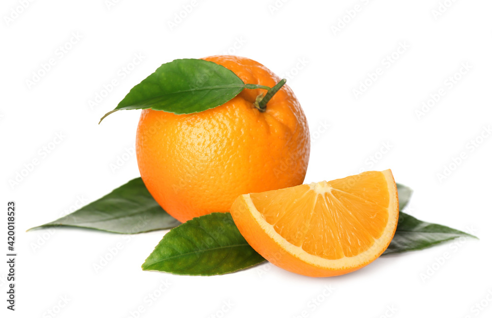 Cut and whole fresh ripe oranges with green leaves on white background