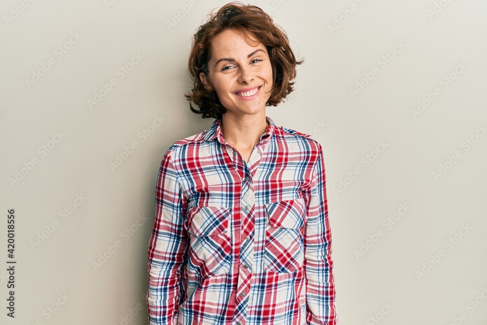 Young brunette woman wearing casual clothes with a happy and cool smile on face. lucky person. Young brunette woman wearing casual clothes with a happy and cool smile on face. lucky person.