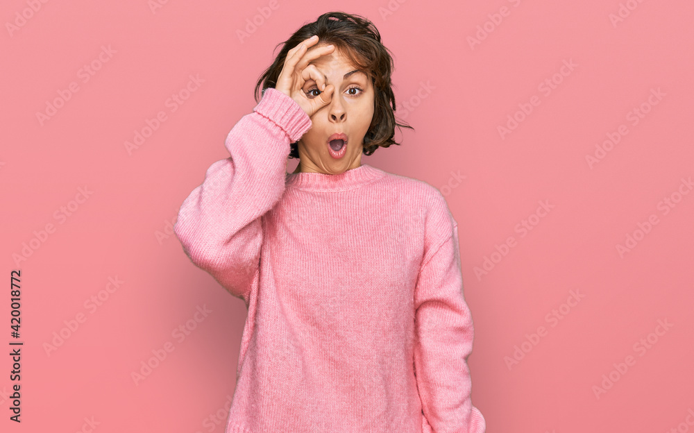 Young hispanic woman wearing casual clothes doing ok gesture shocked with surprised face, eye looking through fingers. unbelieving expression. Young hispanic woman wearing casual clothes doing ok gesture shocked with surprised face, eye looking through fingers. unbelieving expression.
