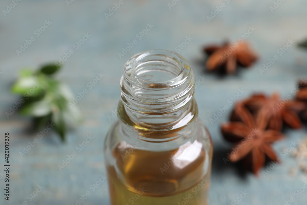 Anise essential oil in bottle on table, closeup Anise essential oil in bottle on table, closeup