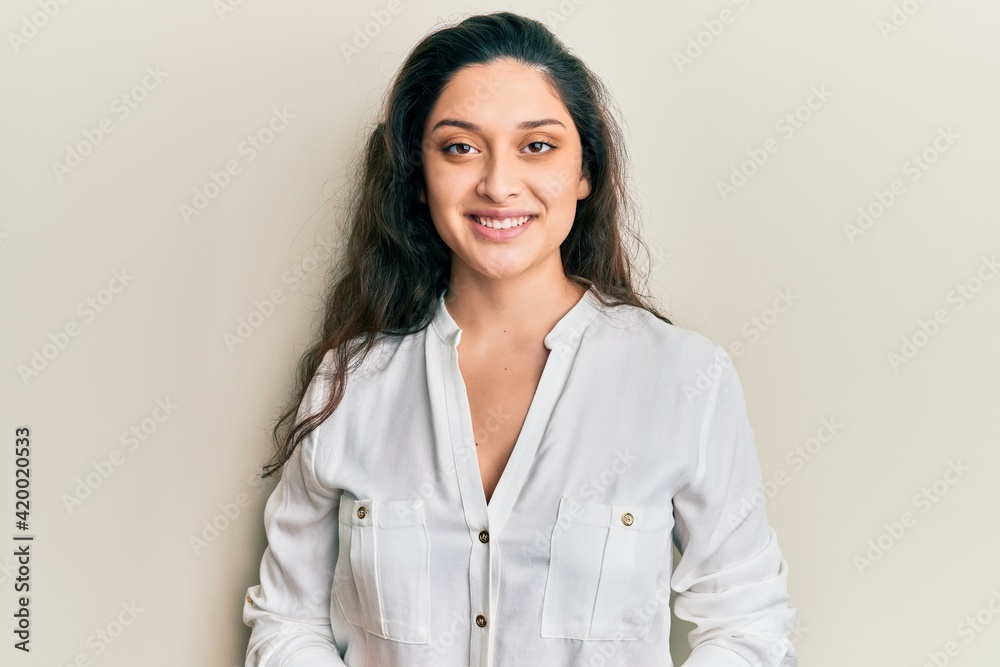 Beautiful middle eastern woman wearing casual clothes with a happy and cool smile on face. lucky person. Beautiful middle eastern woman wearing casual clothes with a happy and cool smile on face. lucky person.