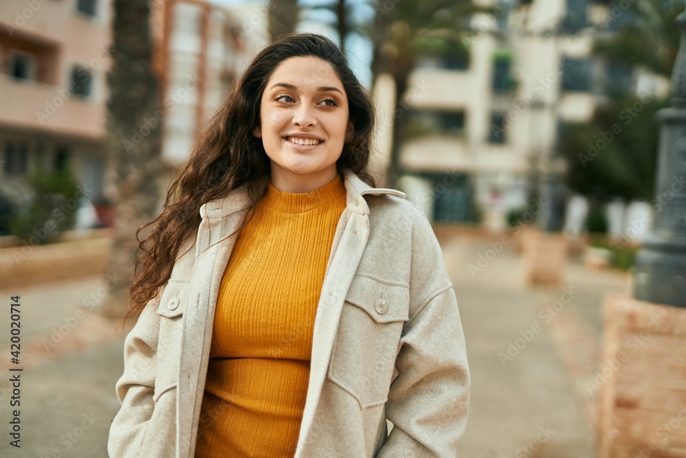 Young middle east woman smiling happy standing at the city. Young middle east woman smiling happy standing at the city.