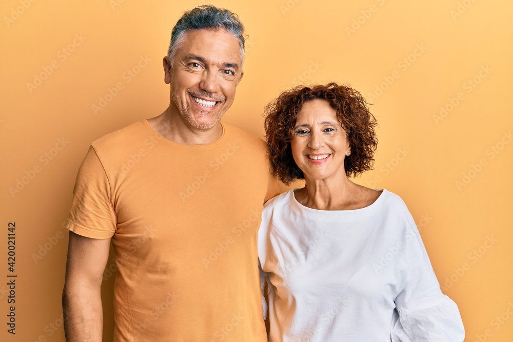 Obraz premium Beautiful middle age couple together wearing casual clothes with a happy and cool smile on face. lucky person.