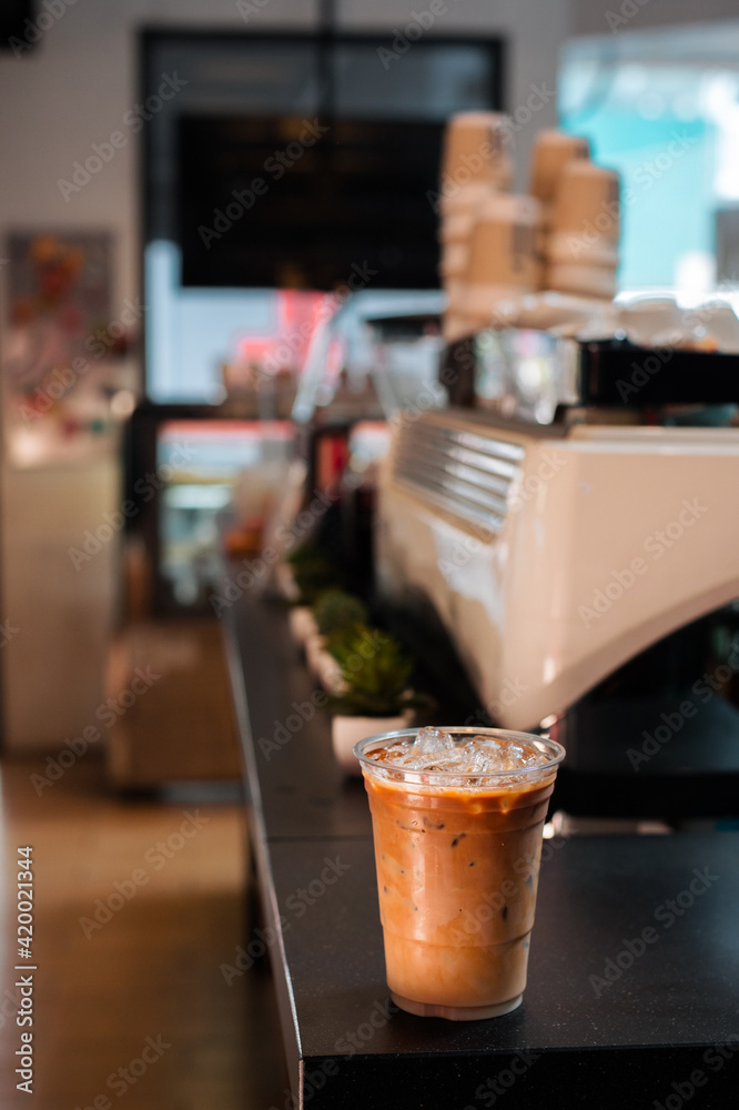 Close-up glass of iced coffee with milk on the table