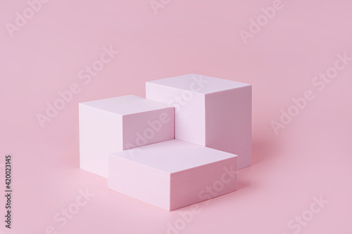 Geometric shapes podium for product display. Monochrome platform on pink background. Stylish background for presentation. Minimal style.
