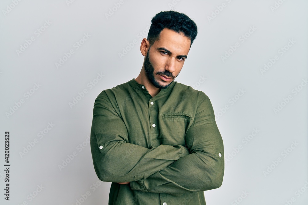 Plakat Young hispanic man wearing casual clothes skeptic and nervous, disapproving expression on face with crossed arms. negative person.