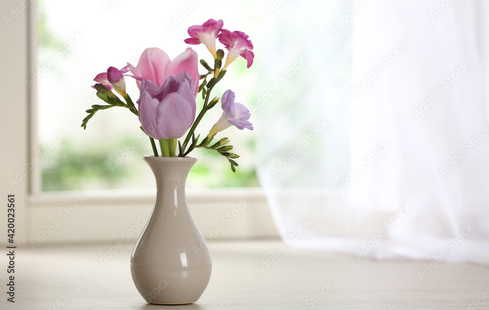 Beautiful fresh flowers on window sill indoors. Space for text Beautiful fresh flowers on window sill indoors. Space for text