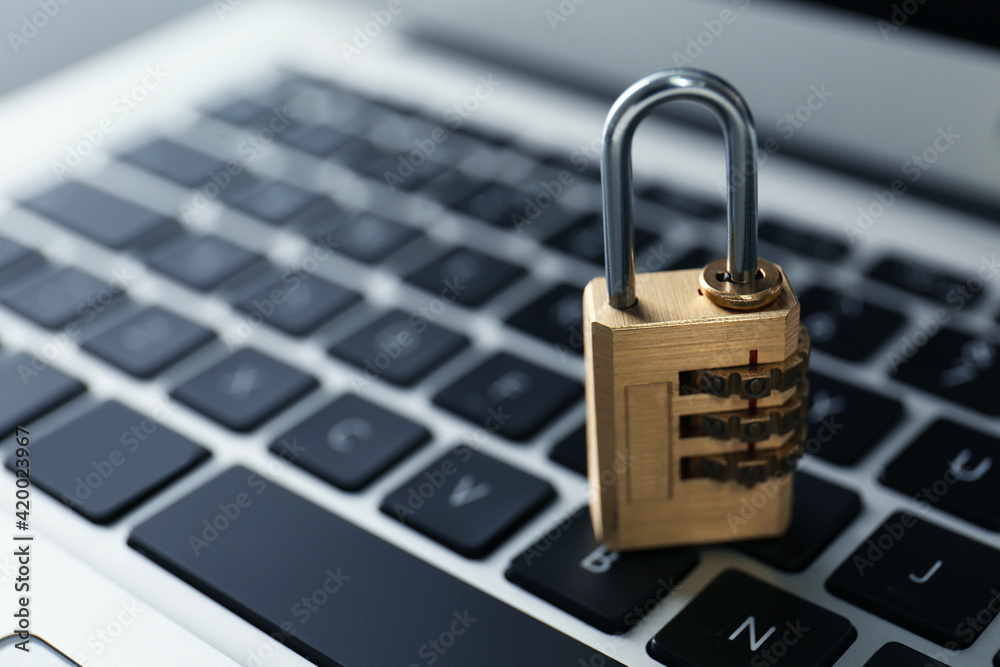 Metal code padlock on laptop keyboard, space for text. Cyber security concept Metal code padlock on laptop keyboard, space for text. Cyber security concept