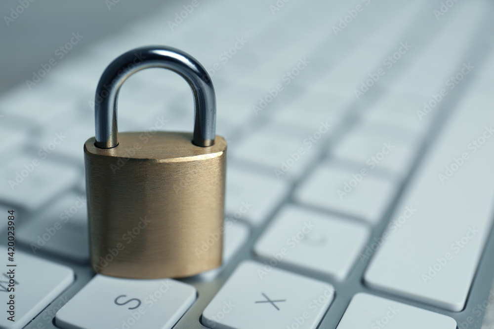 Metal padlock on computer keyboard, space for text. Cyber security concept Metal padlock on computer keyboard, space for text. Cyber security concept