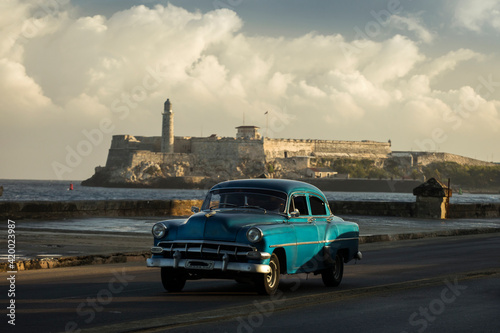 Amazing old american car on streets of Havana with colourful buildings in background. Havana, Cuba. © danmir12