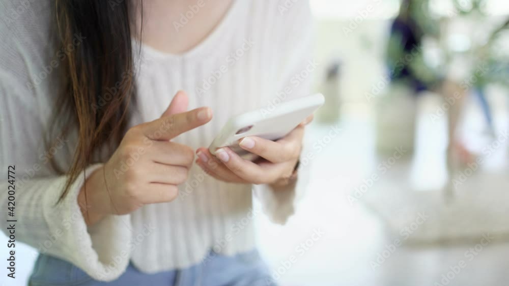 Woman hand using phone pointing finger on screen smartphone texting mobile phone.
Woman hand using phone pointing finger on screen smartphone texting mobile phone.