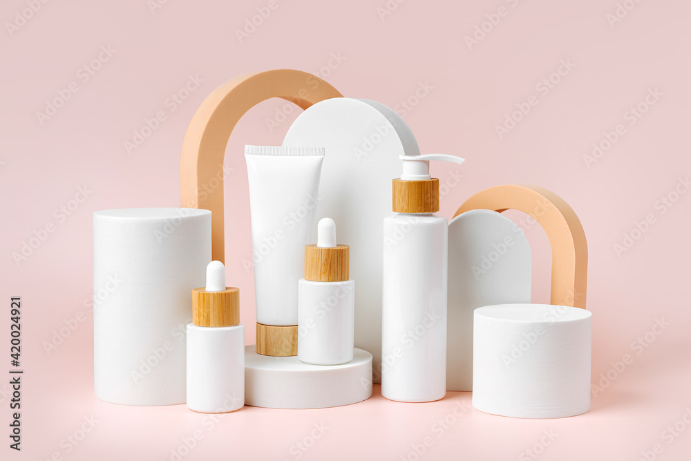 Various blank cosmetic container mock-ups on podiums and geometrical forms. Background for branding and packaging presentation. Natural skincare beauty product concep Various blank cosmetic container mock-ups on podiums and geometrical forms. Background for branding and packaging presentation. Natural skincare beauty product concep