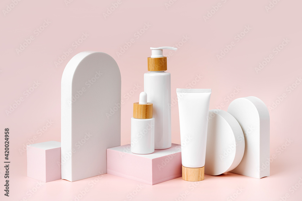 Various blank cosmetic container mock-ups on podiums and geometrical forms. Background for branding and packaging presentation. Natural skincare beauty product concep