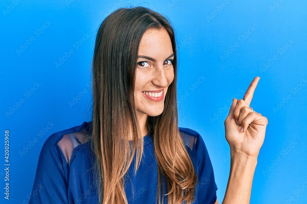Young beautiful woman wearing casual clothes smiling happy pointing with hand and finger to the side Young beautiful woman wearing casual clothes smiling happy pointing with hand and finger to the side