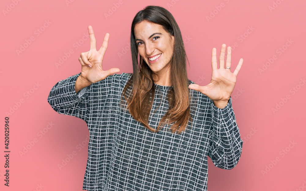 Young beautiful woman wearing casual clothes showing and pointing up with fingers number eight while smiling confident and happy. Young beautiful woman wearing casual clothes showing and pointing up with fingers number eight while smiling confident and happy.