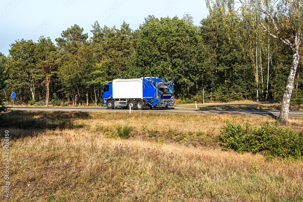 garbage truck against the background of rural areas garbage truck against the background of rural areas