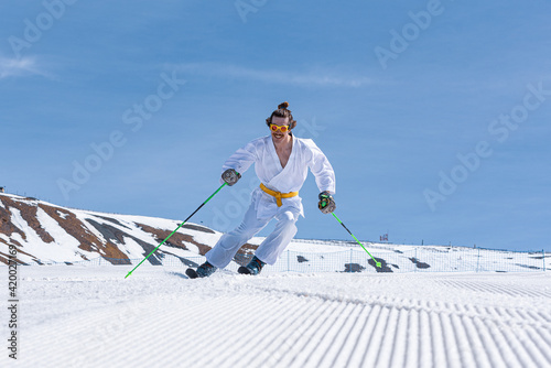 Skier dressed as a karateka at a ski station photo