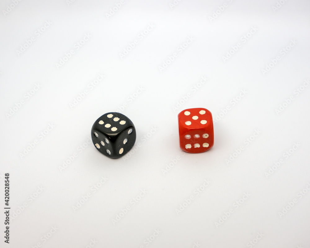 Red and black dice on a white background. Red dice shows five and black dice shows six. Red and black dice on a white background. Red dice shows five and black dice shows six.
