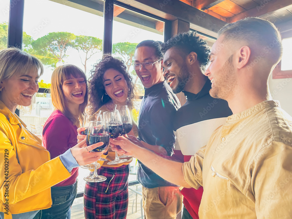 Friends toasting and drinking red wine at restaurant - Food lifestyle concept with happy people having fun together - Concept about with happy people having fun together at winery bar