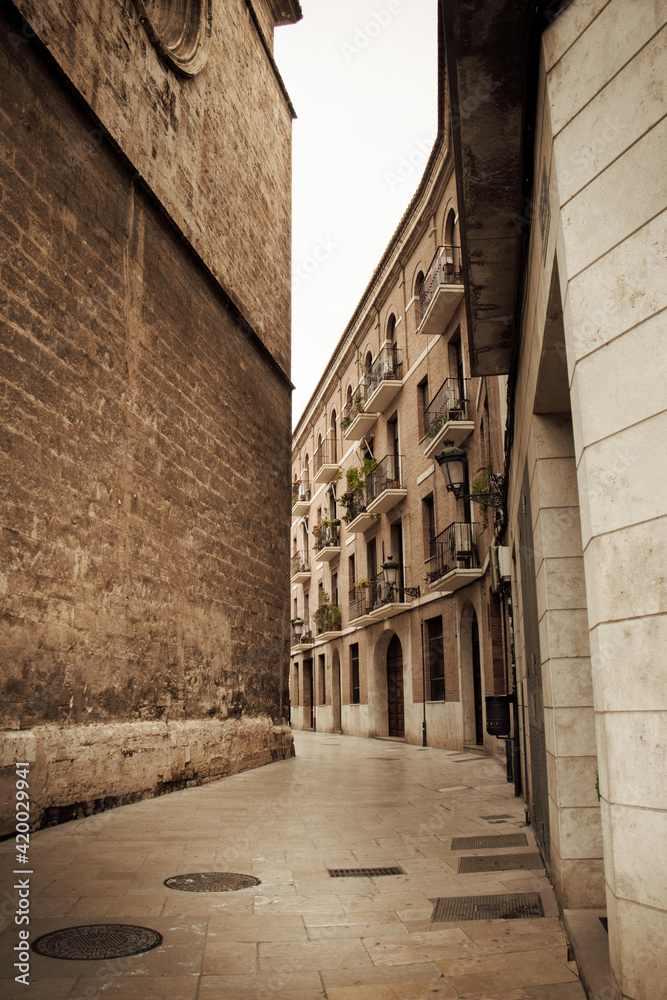 Old, stone-walled city streets in Valencia, Spain